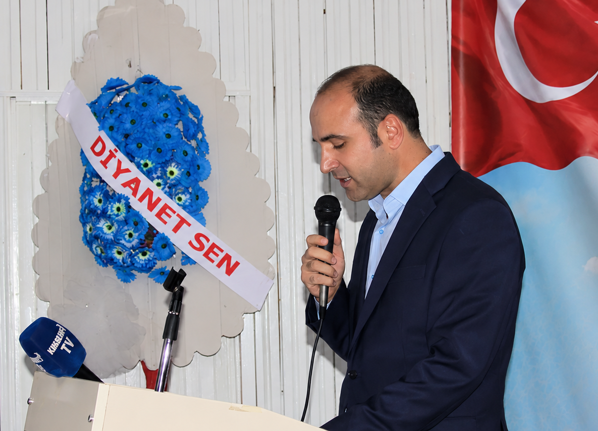 Kürsüde Konuşan Adam Ve Mavi Çelenk (1)